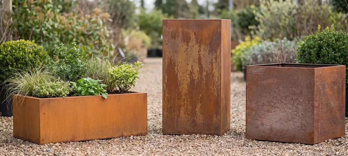 Rectangular, tall, and square Corten steel planters with rusted patina on display